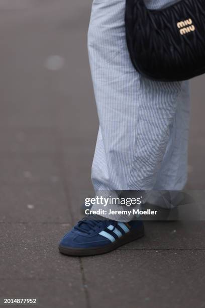 Victoria Thomas seen wearing Hernameis white / blue striped long pants, Miu Miu black leather quilted bag and Adidas Spezial navy blue suede leather...