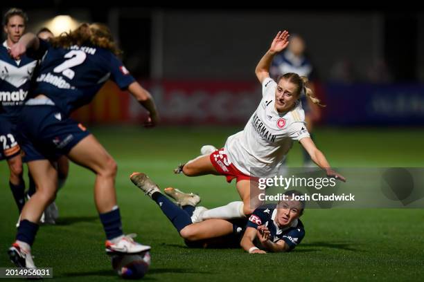 Holly Caspers of the Wanderers trips over Sara D'Appolonia of Melbourne Victory during the A-League Women round 17 match between Melbourne Victory...