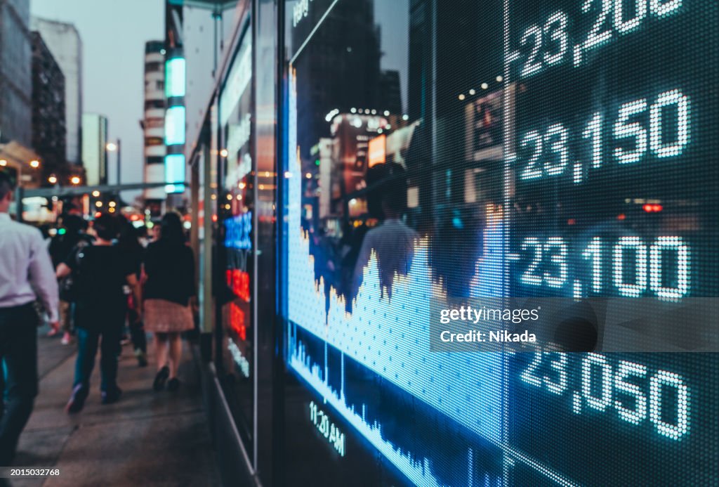 Digital Stock Market Display in an Urban Setting at Twilight