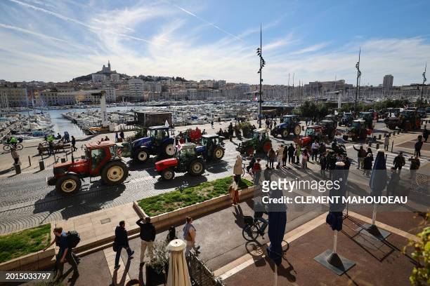Protestors drive tractors at the Vieux Port as part of a demonstration of French farmers against agricultural policies, in Marseille on February 19,...