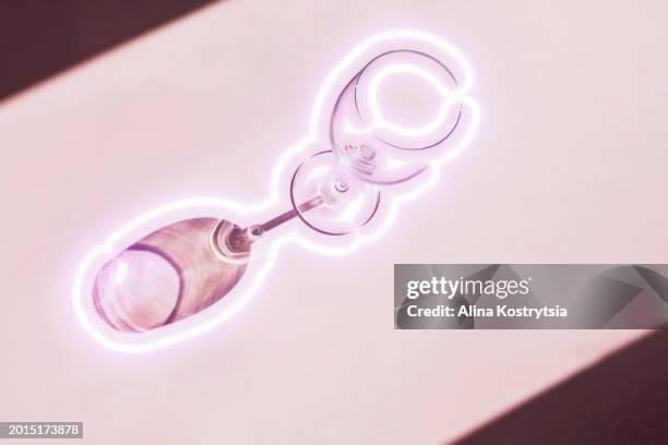 shadow from glass with glowing neon stroke on pink background - empty glasses after party stock pictures, royalty-free photos & images