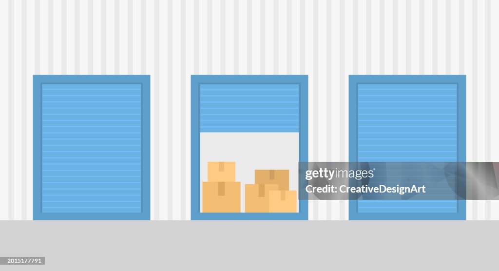 Close-up View Of Warehouse Building With Self Storage Units. Cardboard Boxes Inside The Open Unit