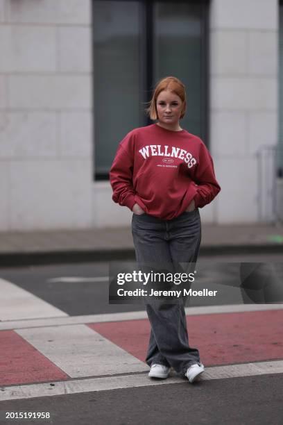 Elena Przkora seen wearing gold earrings, Hernameis burgundy red oversized cotton sweater, Weekday grey denim / jeans wide leg pants and Alexander...