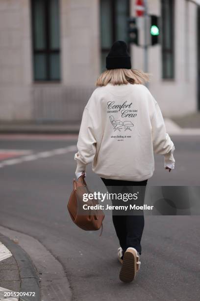 Elise Rozay seen wearing Hernameis black wool knit logo patch beanie, Hernameis creamy white logo print pattern oversized sweater, Zara black split...