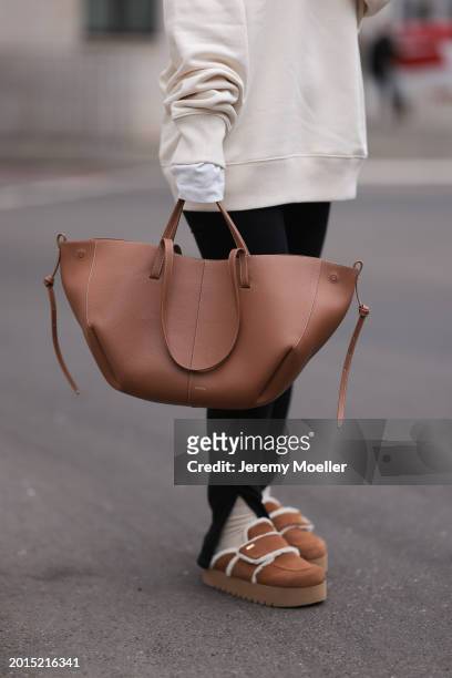 Elise Rozay seen wearing Hernameis creamy white logo print pattern oversized sweater, Zara black split leggings pants, Hernameis beige wool knit...