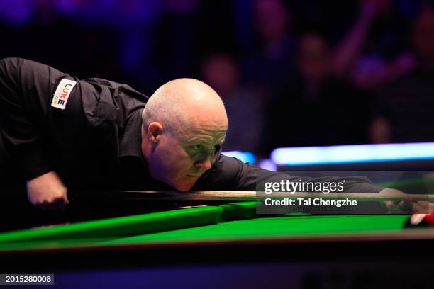 John Higgins of Scotland plays a shot in the Quarterfinal match against Mark Allen of Northern Ireland on day five of 2024 Betvictor Welsh Open at...