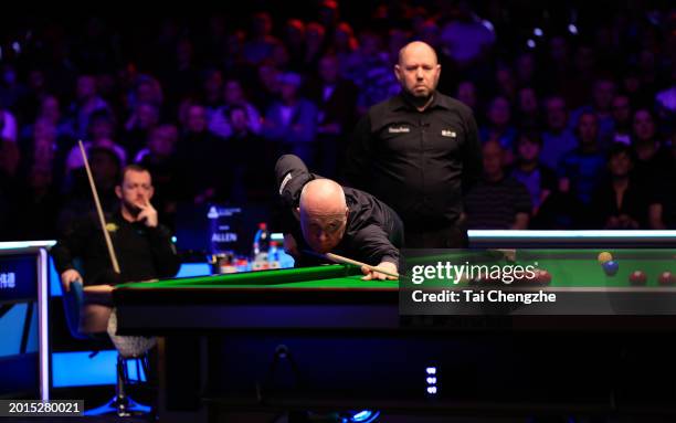 John Higgins of Scotland plays a shot in the Quarterfinal match against Mark Allen of Northern Ireland on day five of 2024 Betvictor Welsh Open at...