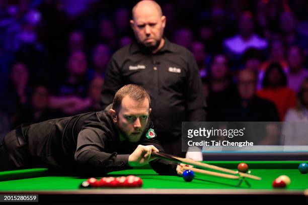 Mark Allen of Northern Ireland plays a shot in the Quarterfinal match against John Higgins of Scotland on day five of 2024 Betvictor Welsh Open at...