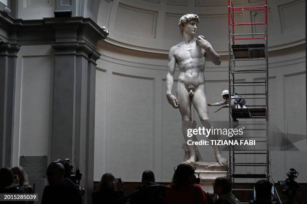 Italian restorer Eleonora Pucci cleans Michelangelo's statue of David using a backpack vacuum and synthetic fibre brush at the Galleria...