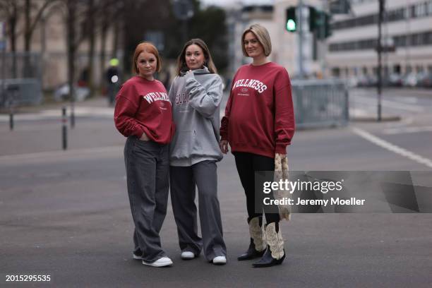 Elena Przkora seen wearing gold earrings, Hernameis burgundy red oversized cotton sweater, Weekday grey denim / jeans wide leg pants and Alexander...