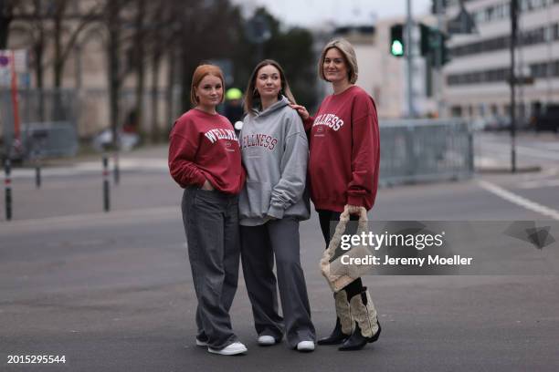 Elena Przkora seen wearing gold earrings, Hernameis burgundy red oversized cotton sweater, Weekday grey denim / jeans wide leg pants and Alexander...