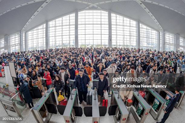 Passengers wait to board their trains at Wenzhou South Railway Station in Wenzhou, east China's Zhejiang Province, Feb. 17, 2024. China witnessed an...