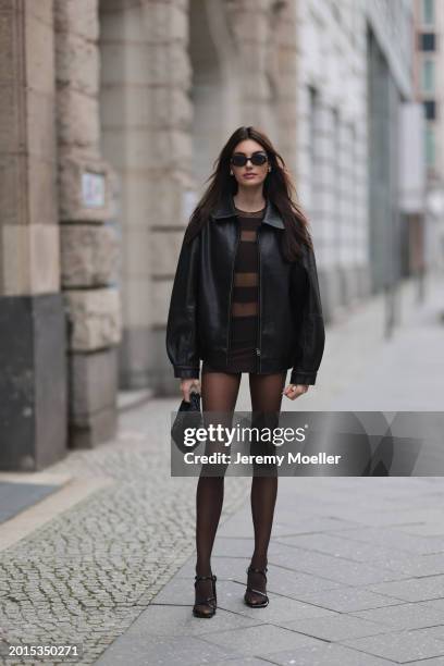 Celine Bethmann seen wearing Chanel vintage black oval sunglasses, Dior gold earrings, Norma Kamali brown / transparent striped short dress, Wolford...