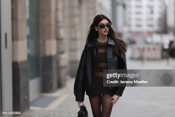 Celine Bethmann seen wearing Chanel vintage black oval sunglasses, Dior gold earrings, Norma Kamali brown / transparent striped short dress, Wolford...