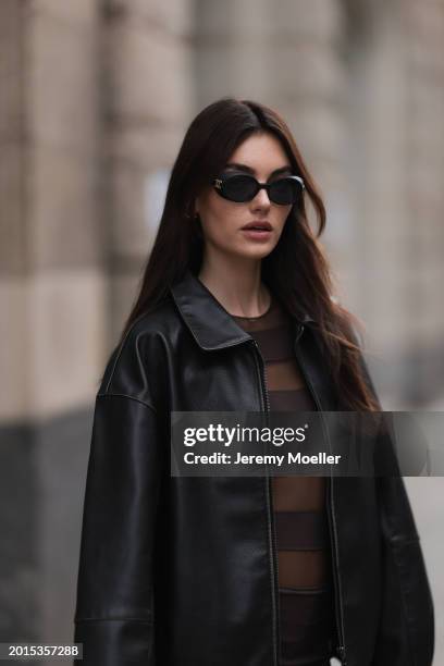 Celine Bethmann seen wearing Chanel vintage black oval sunglasses, Dior gold earrings, Norma Kamali brown / transparent striped short dress and a...