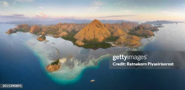 aerial view of ship in komodo national park at sunset scene, indonesia - lawn aeration stock pictures, royalty-free photos & images