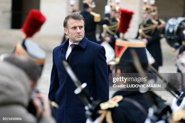 French President Emmanuel Macron reviews troops during a "Prise d'armes" military ceremony in the courtyard of the Hotel National des Invalides in...