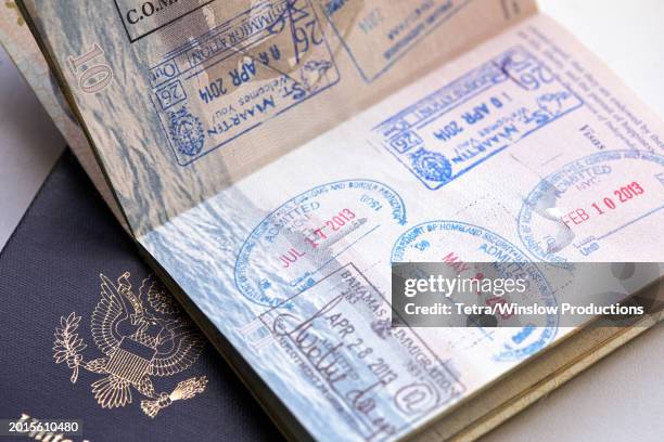 studio shot of us passports with stamps - passport stamp stock pictures, royalty-free photos & images
