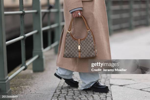 Sophia Geiss is seen wearing silver rings, LeGer light blue wide leg denim / baggy jeans, LeGer beige oversized long wool coat, Gucci brown / beige...