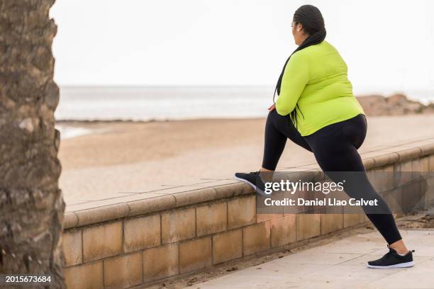 woman stretching outdoors - sport determination stock pictures, royalty-free photos & images