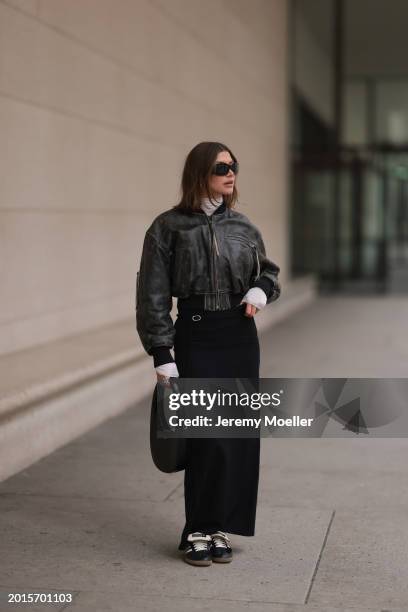 Sophia Geiss is seen wearing Mango black sunglasses, Acne Studios black / grey leather bomber jacket, Intimissimi white sheer high neck cashmere top,...