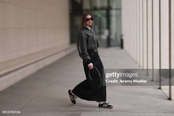 Sophia Geiss is seen wearing Mango black sunglasses, Acne Studios black / grey leather bomber jacket, silver rings, Intimissimi white sheer high neck...