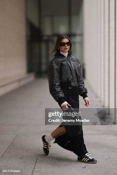 Sophia Geiss is seen wearing Mango black sunglasses, Acne Studios black / grey leather bomber jacket, silver rings, Intimissimi white sheer high neck...