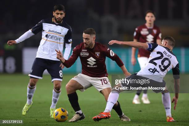 Nikola Vlasic of Torino FC takes on Hamza Rafia and Alexis Blin of US Lecce during the Serie A TIM match between Torino FC and US Lecce - Serie A TIM...