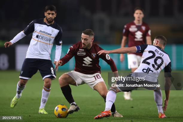 Nikola Vlasic of Torino FC takes on Hamza Rafia and Alexis Blin of US Lecce during the Serie A TIM match between Torino FC and US Lecce - Serie A TIM...