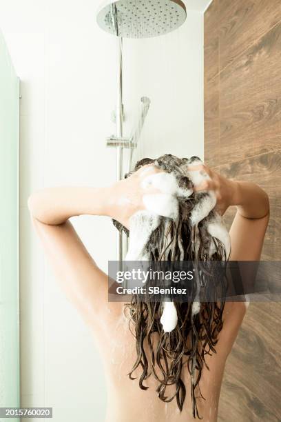 woman washing her hair in shower - wet hair conditioner stock pictures, royalty-free photos & images