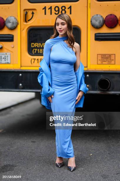 Guest wears a blue full look, a gathered halter top / asymmetric long silk dress, a oversized blazer jacket , silver pointed shoes , outside La...