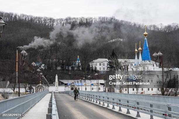 Ukrainian workers close to completing rebuilding a bridge over the Siverskyi Donets River that was destroyed by Ukrainian forces to slow an advance...