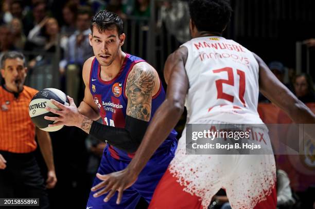 Willy Hernangomez of FC Barcelona and Selom Mawugbe of BAXI Manresa in action during Quarter Finals of Copa del Rey 2024 at Martin Carpena Arena on...