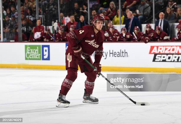 Juuso Valimaki of the Arizona Coyotes skates with the puck against the Minnesota Wild at Mullett Arena on February 14, 2024 in Tempe, Arizona.