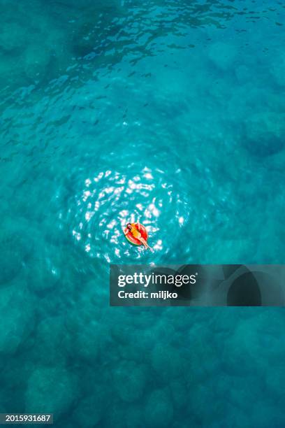 woman relaxing and swimming in clear sea water - beach holiday stock pictures, royalty-free photos & images