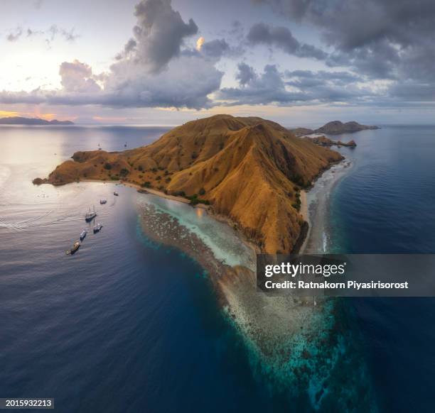 aerial view of ship in komodo national park at sunset scene, indonesia - lawn aeration stock pictures, royalty-free photos & images