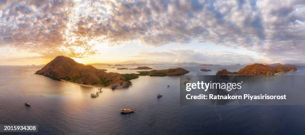 aerial view of ship in komodo national park at sunset scene, indonesia - lawn aeration stock pictures, royalty-free photos & images