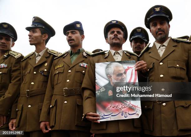 Police academy cadet holds a picture depicting the former commander of the Islamic Revolutionary Guard Corps Quds Force, Major General Qassem...