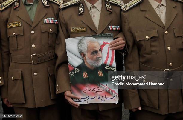 Police academy cadet holds a picture depicting the former commander of the Islamic Revolutionary Guard Corps Quds Force, Major General Qassem...