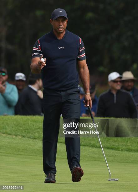 Tiger Woods of the United States reacts to a birdie putt on the first green during the second round of The Genesis Invitational at Riviera Country...