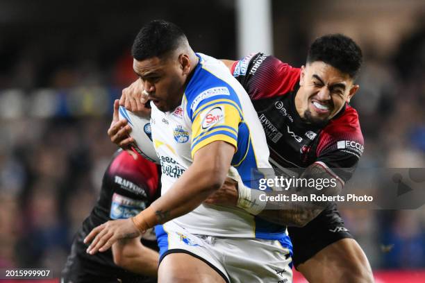 Sam Lisone of Leeds Rhinos is tackled by Tim Lafai of Salford Red Devils during the Betfred Super League match between Leeds Rhinos and Salford Red...