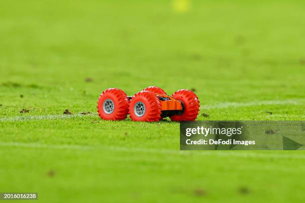 Fans of 1.FC Koeln drive across the pitch with remote-controlled cars during the Bundesliga match between 1. FC Köln and SV Werder Bremen at...