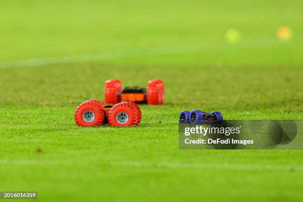 Fans of 1.FC Koeln drive across the pitch with remote-controlled cars during the Bundesliga match between 1. FC Köln and SV Werder Bremen at...