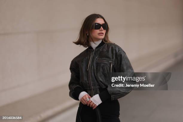 Sophia Geiss is seen wearing Mango black sunglasses, Acne Studios black / grey leather bomber jacket, Intimissimi white sheer high neck cashmere top,...