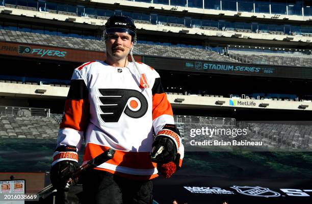 Scott Laughton of the Philadelphia Flyers makes his way to the ice surface for a team photo before practice at MetLife Stadium on February 16, 2024...