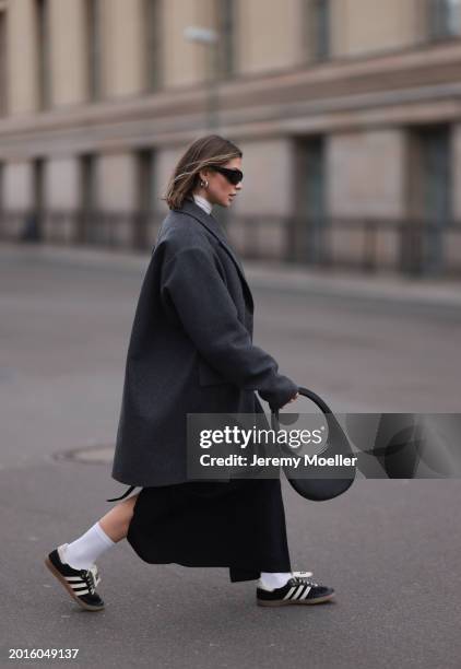 Sophia Geiss is seen wearing Mango black sunglasses, Cos grey oversized long blazer jacket, Intimissimi white sheer high neck cashmere top, Edited...