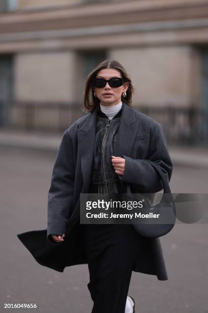 Sophia Geiss is seen wearing Mango black sunglasses, Acne Studios black / grey leather bomber jacket, Cos grey oversized long blazer jacket,...