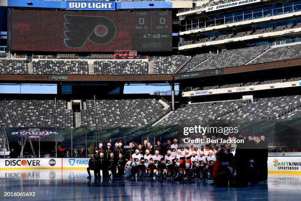 The Philadelphia Flyers pose at center ice for a team photo before practice at MetLife Stadium on February 16, 2024 in East Rutherford, New Jersey.