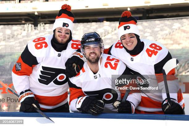 Joel Farabee, Ryan Poehling and Morgan Frost of the Philadelphia Flyers look on before a team photo at MetLife Stadium on February 16, 2024 in East...