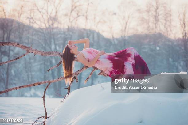 young woman relaxes in winter landscape - spaghetti straps stock pictures, royalty-free photos & images